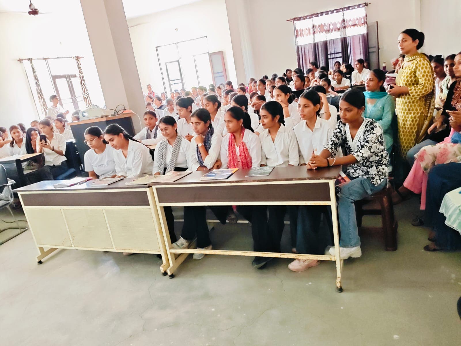 Faculty and students filling the hall for the orientation session