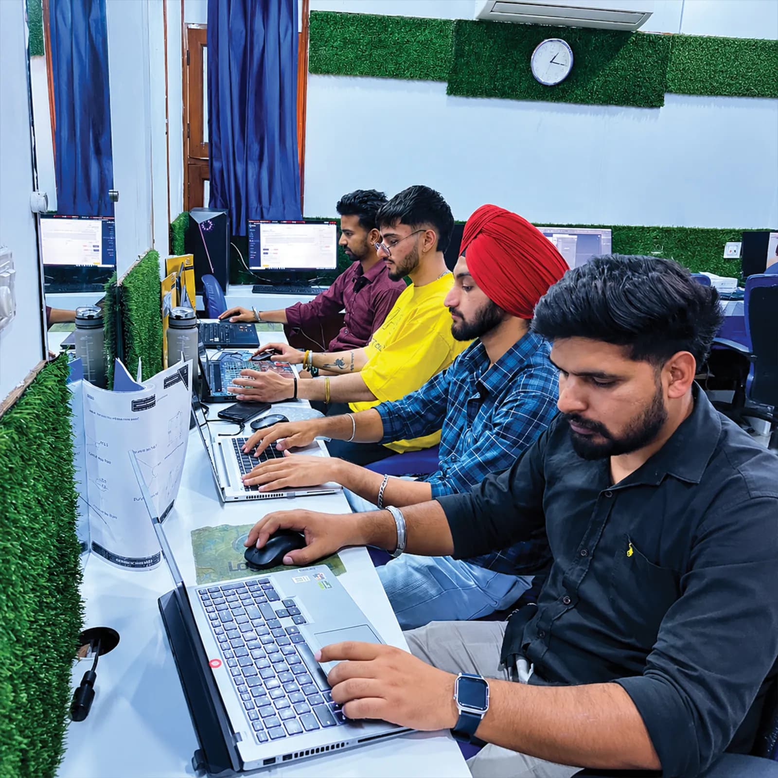 Students working side by side on their laptops