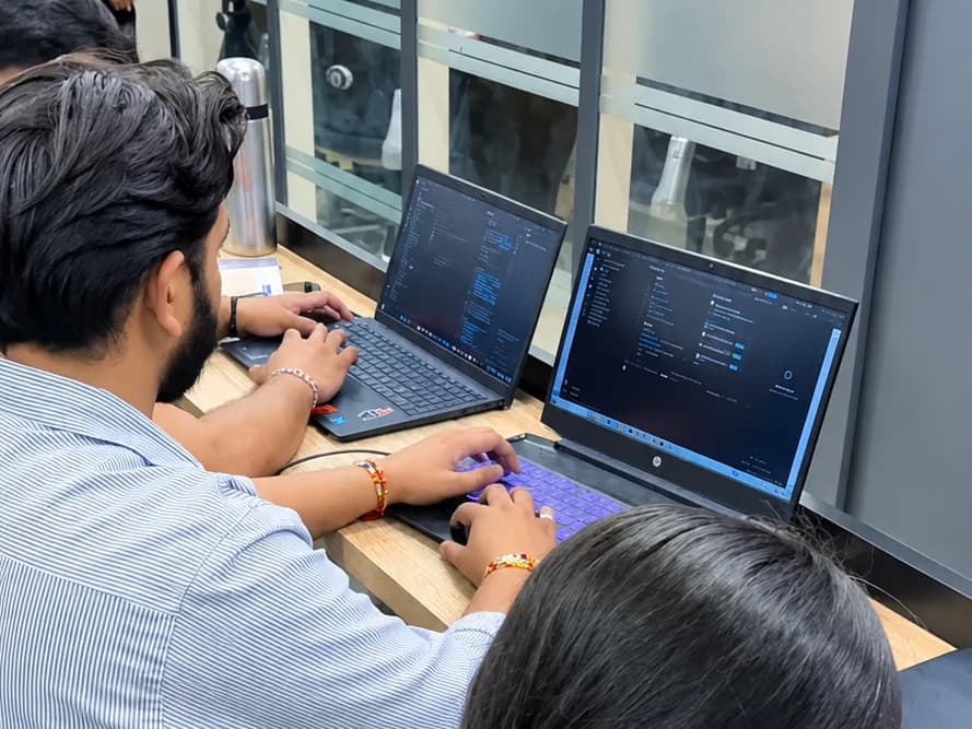 Students writing code on their laptops