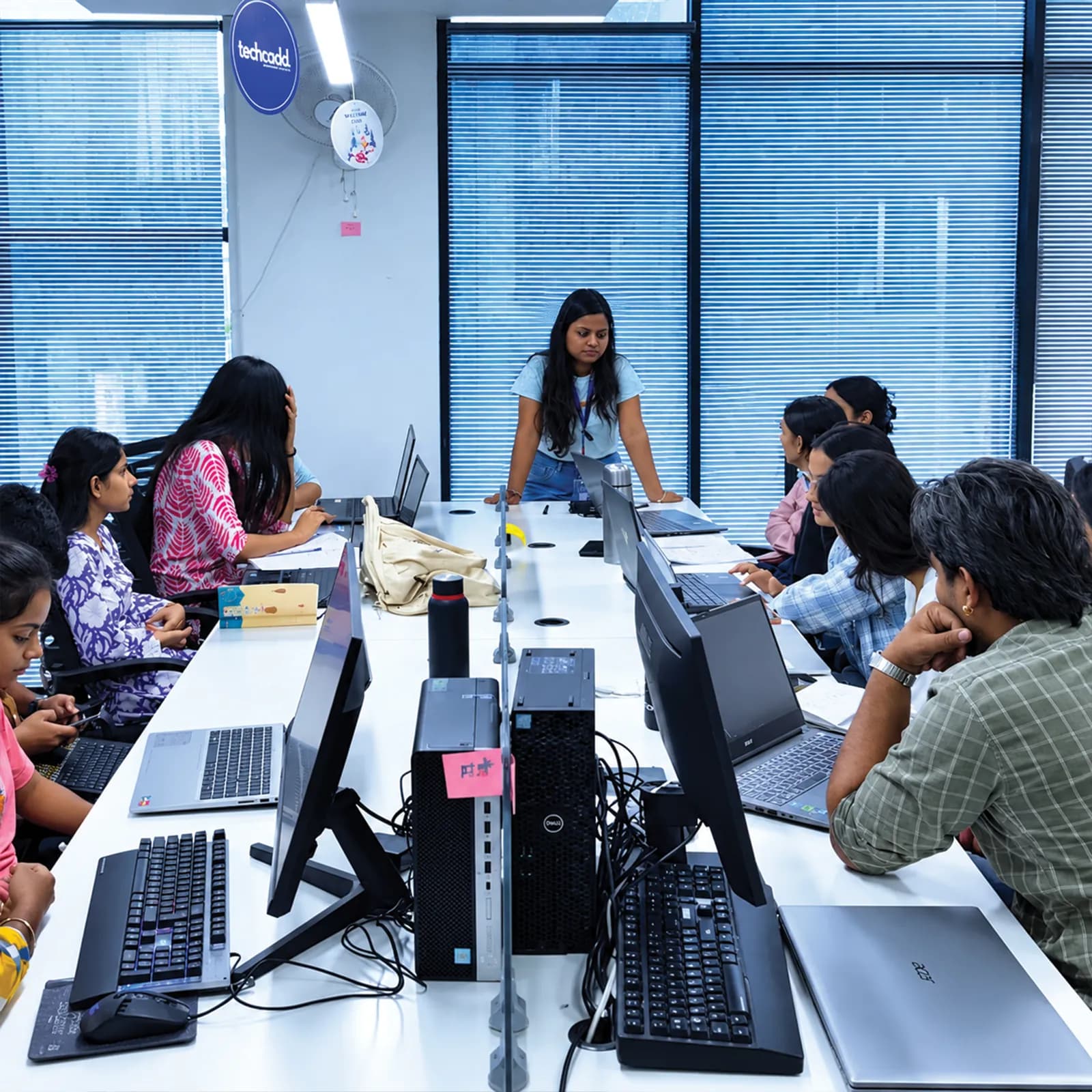 Trainer leading a group session at the long lab table